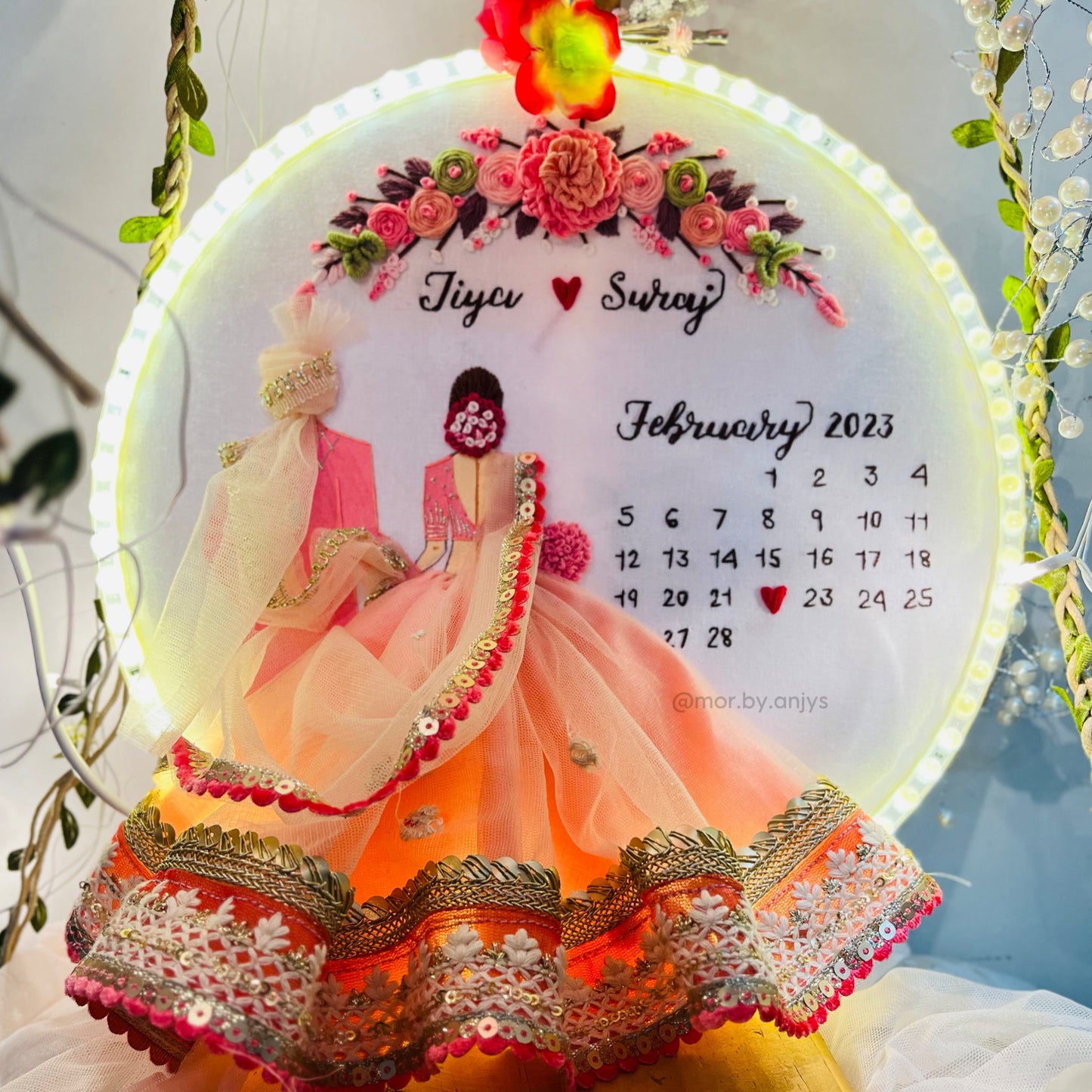 Decorative calendar with a couple's illustration and floral design, featuring the name 'Tiyu' and 'Sway'.