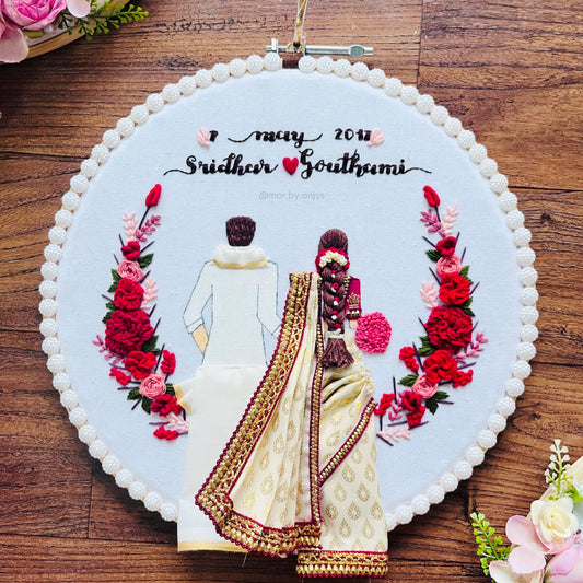Embroidery of a couple with flowers on a wooden surface for south indian wedding