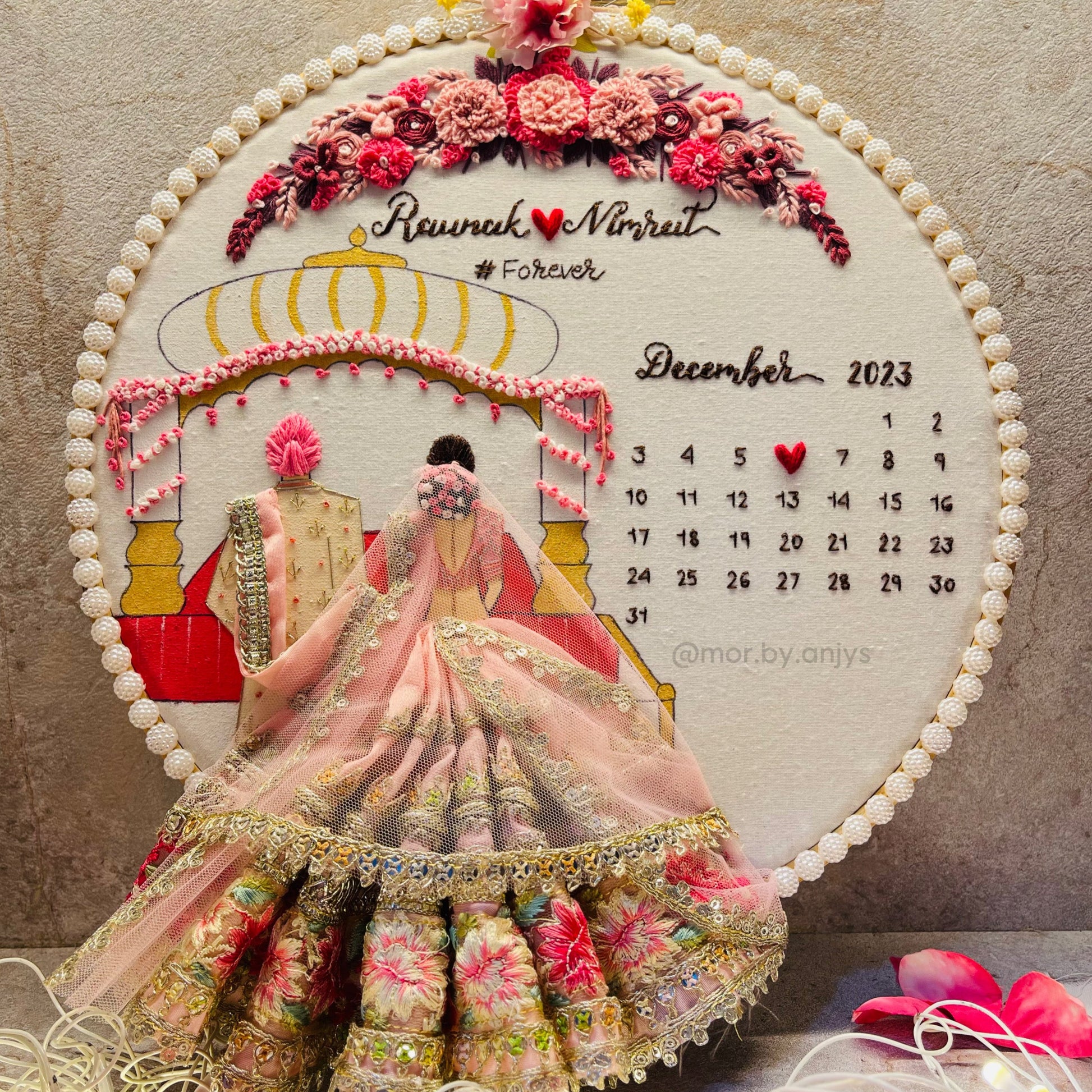 Decorative calendar with floral design and bride's portrait on a textured background