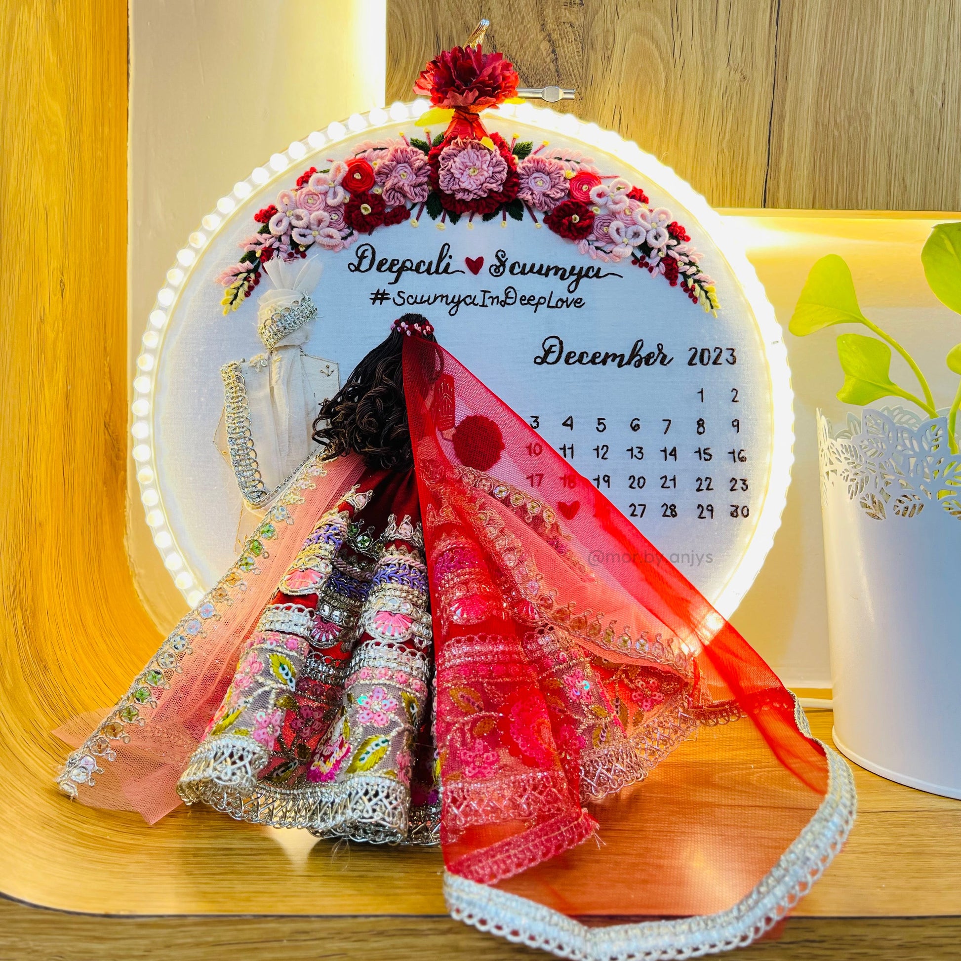 Decorative calendar with a person in traditional attire on a wooden surface