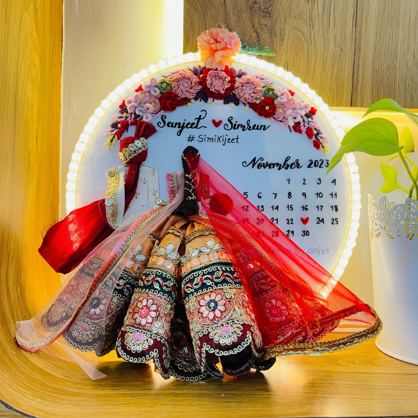 Decorative calendar with a bride and groom design on a wooden surface
