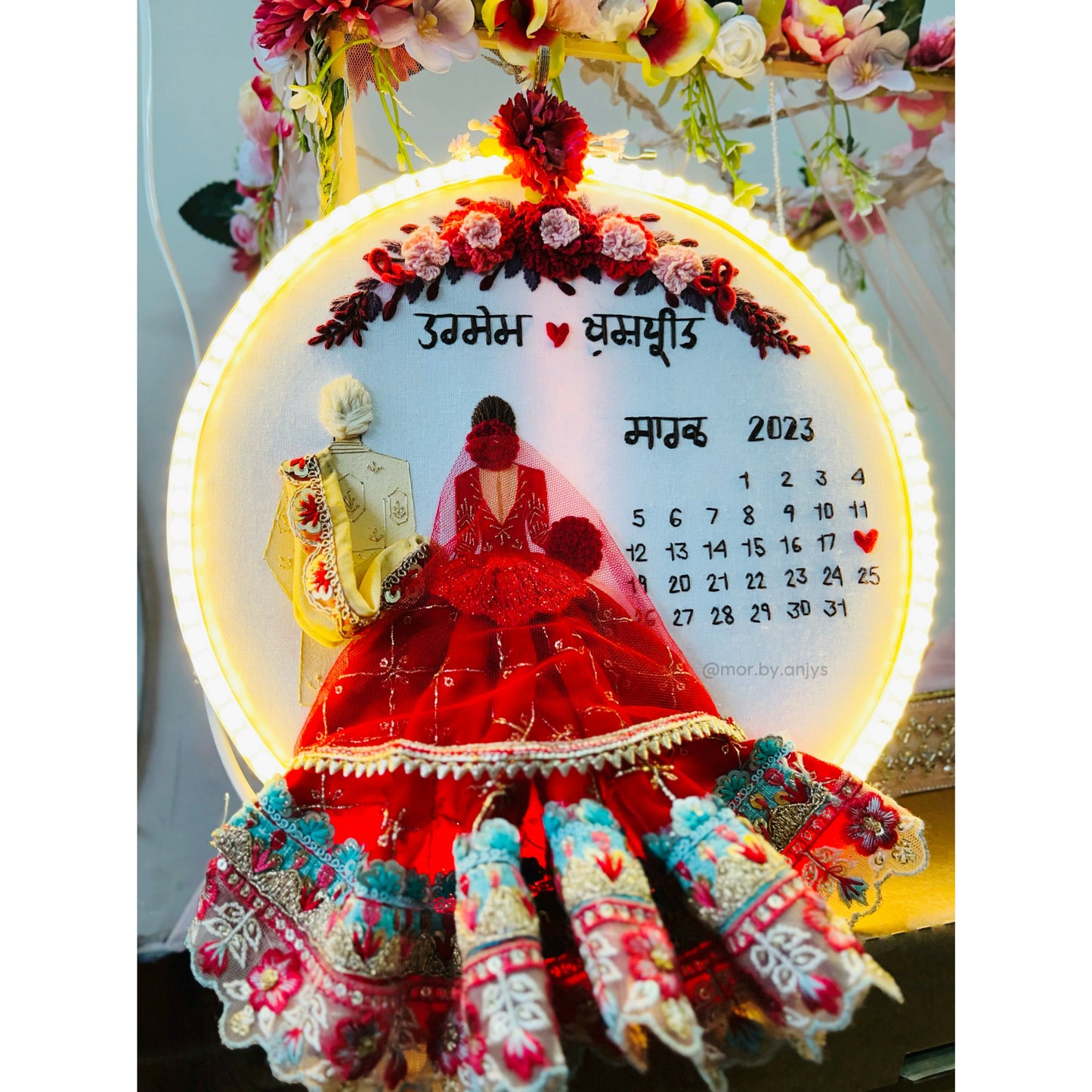 Decorative calendar with a couple in traditional attire and floral decorations.