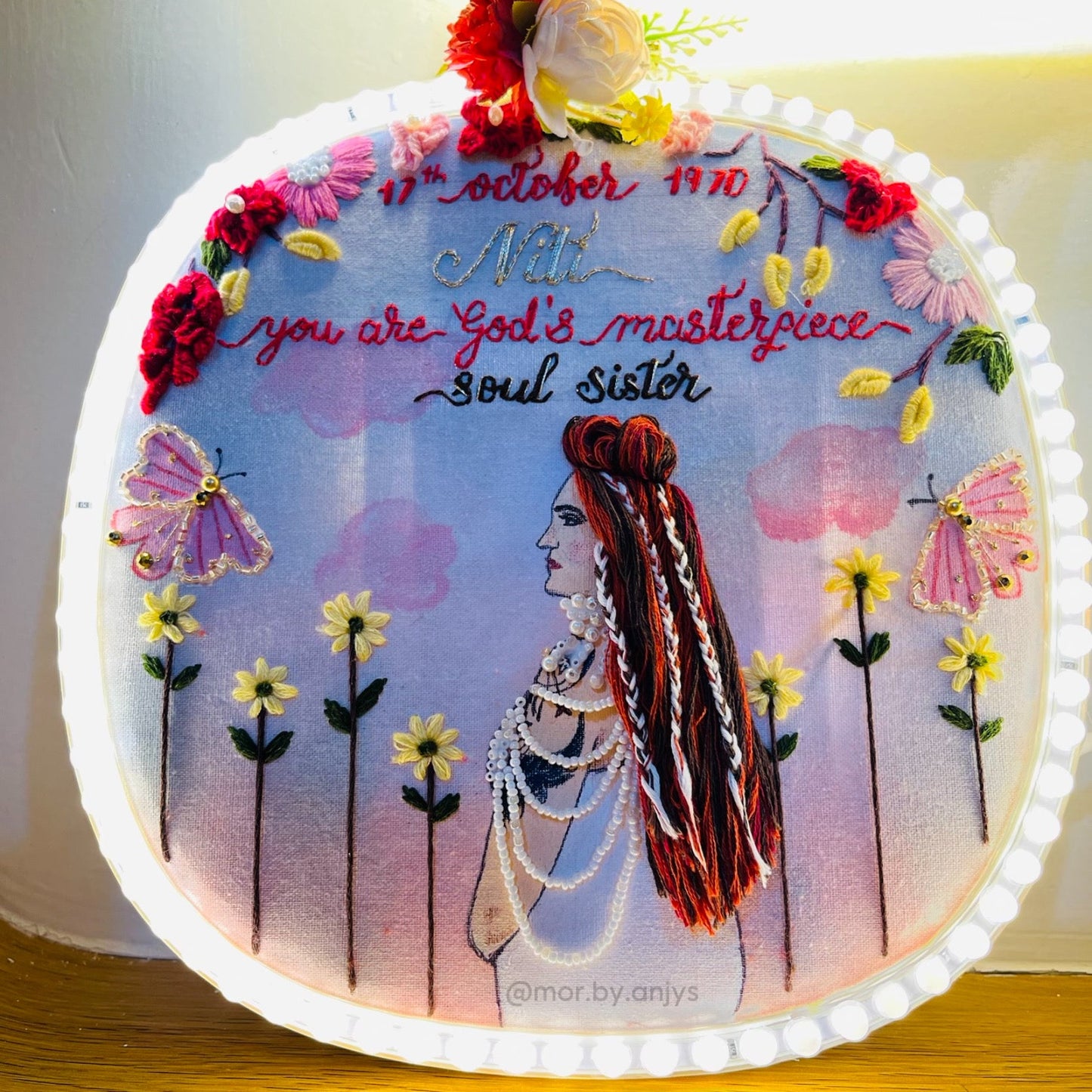 Decorative pillow with artistic design of a woman, flowers, and text on a white background.